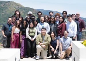 Group of students pose in front of a mountain range in Malibu, California. 