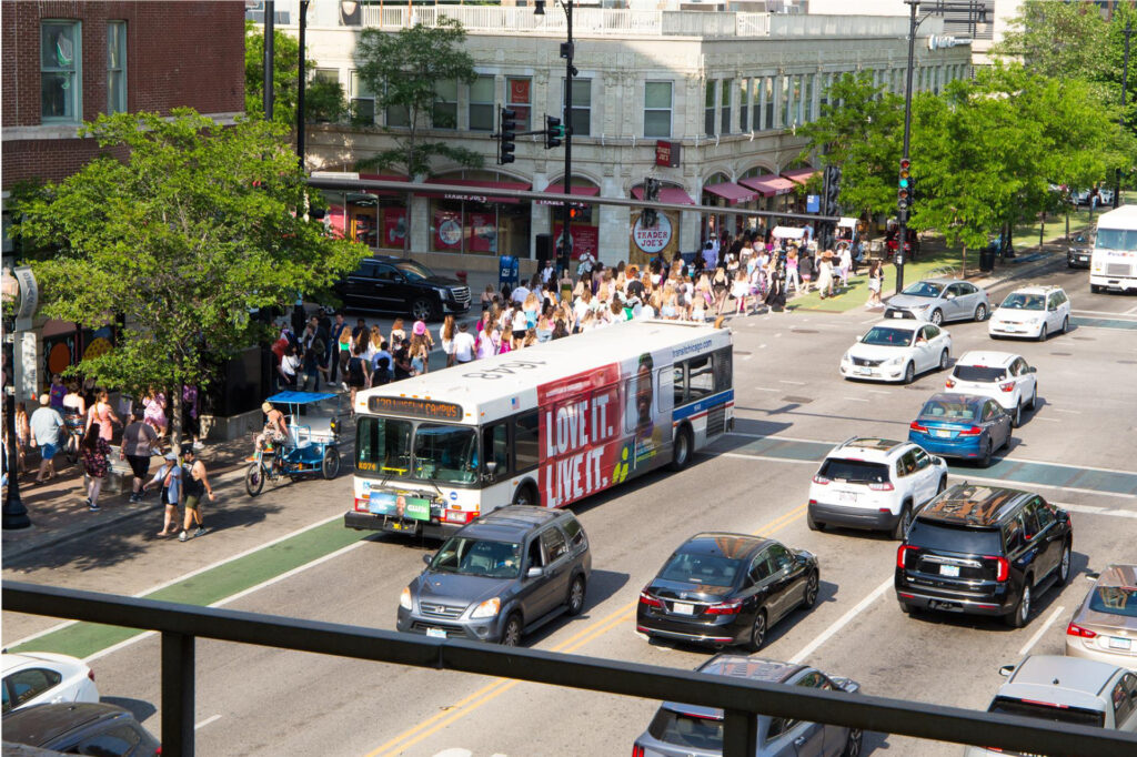 CTA bus featuring a photo of Kye Adams driving through Chicago.